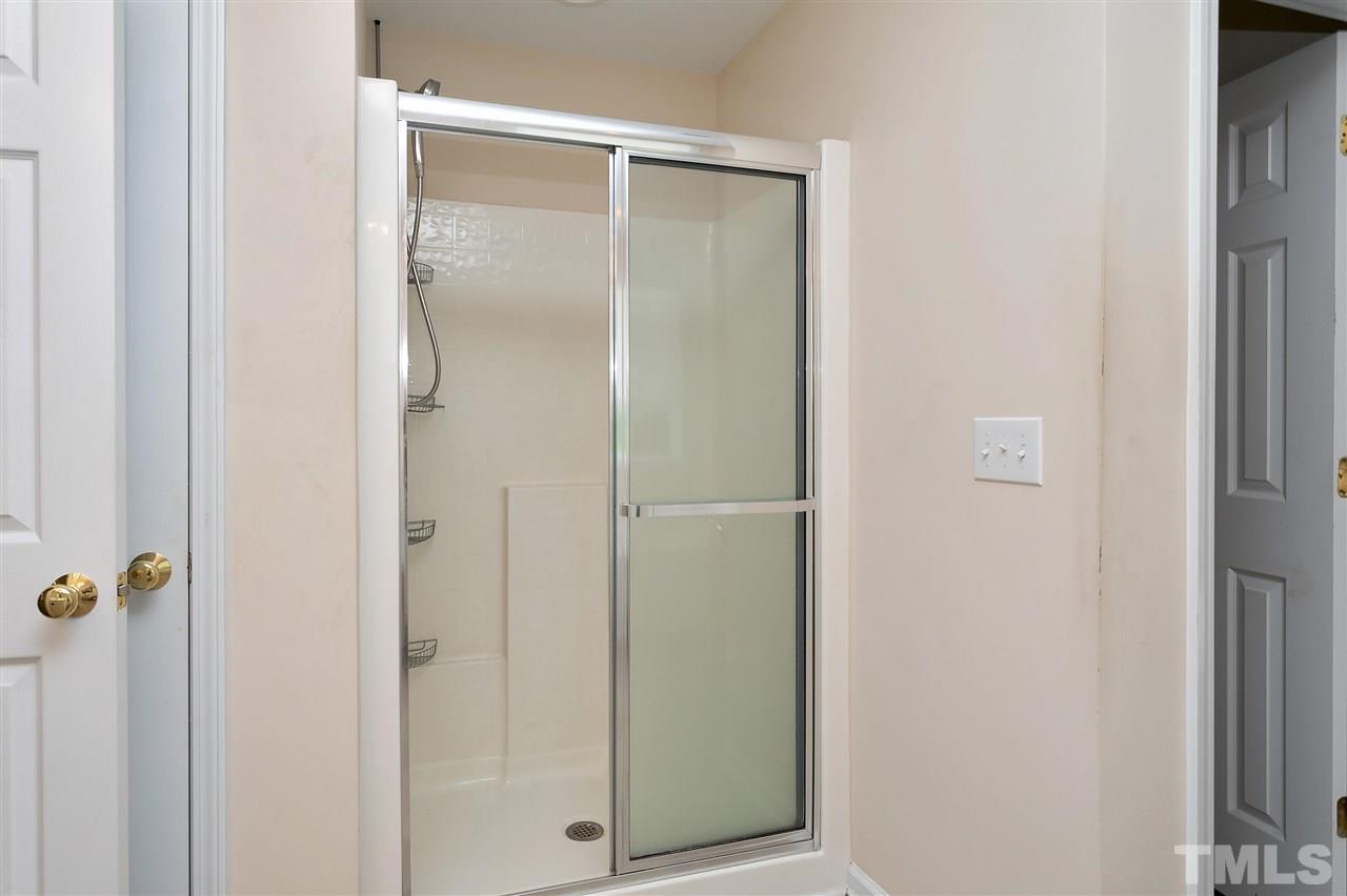220 Mickleson Ridge Drive Raleigh, NC 27603 - Photo 11 of 20 a bathroom with a glass shower door