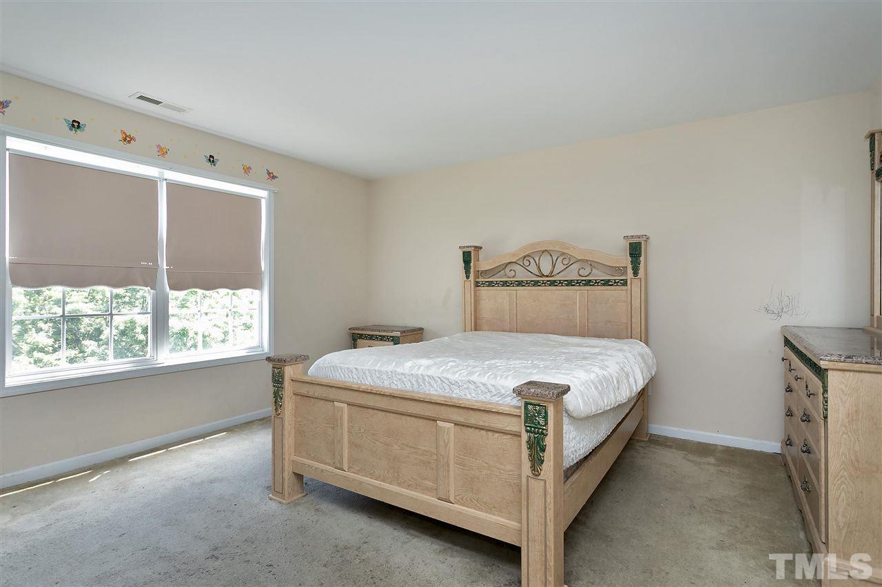220 Mickleson Ridge Drive Raleigh, NC 27603 - Photo 13 of 20 a bedroom with a bed and window