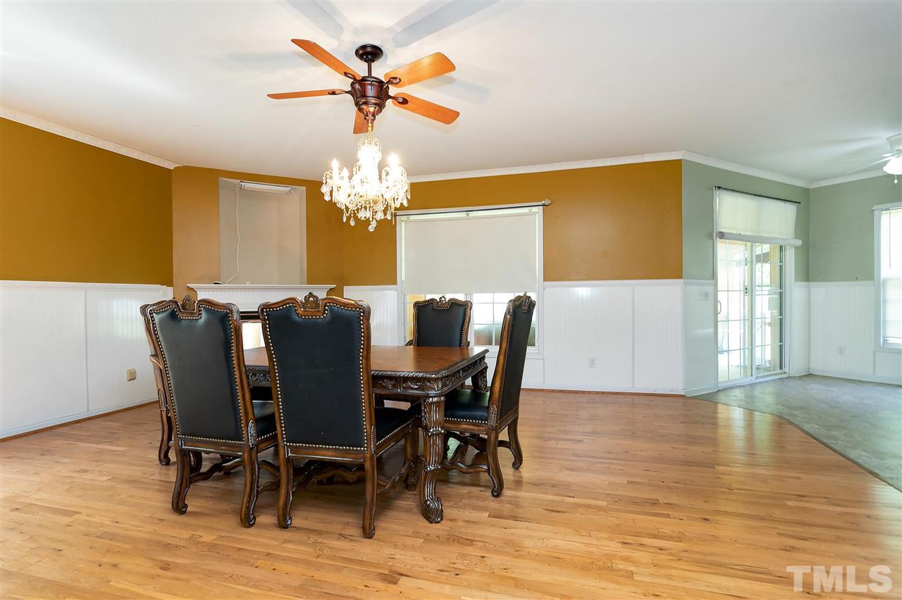 220 Mickleson Ridge Drive Raleigh, NC 27603 - Photo 3 of 20 a view of a dining room with furniture and chandelier