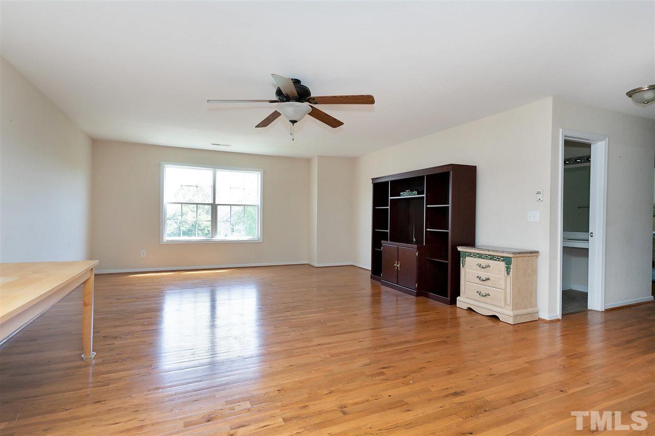 220 Mickleson Ridge Drive Raleigh, NC 27603 - Photo 7 of 20 a view of an empty room with window and wooden floor