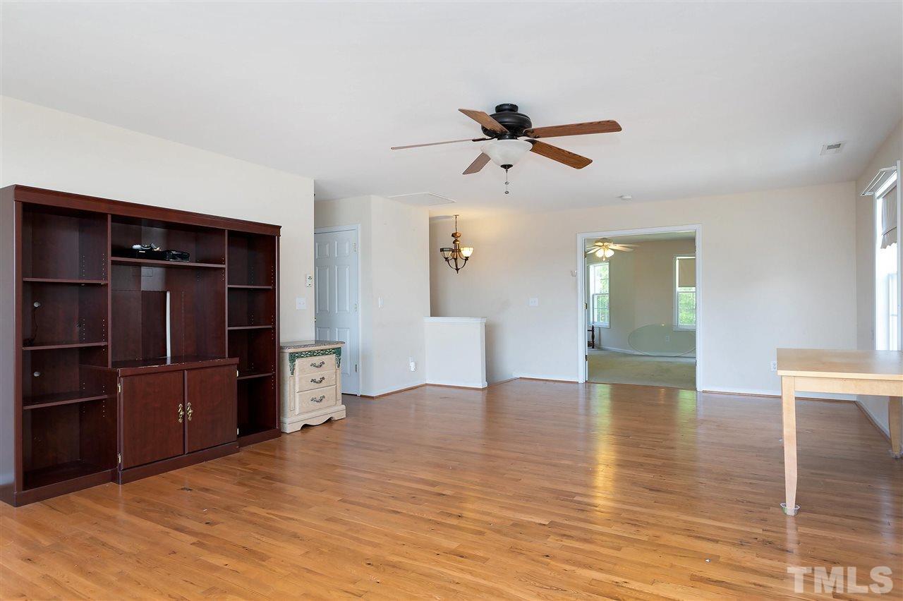 220 Mickleson Ridge Drive Raleigh, NC 27603 - Photo 8 of 20 a view of empty room with wooden floor and cabinet
