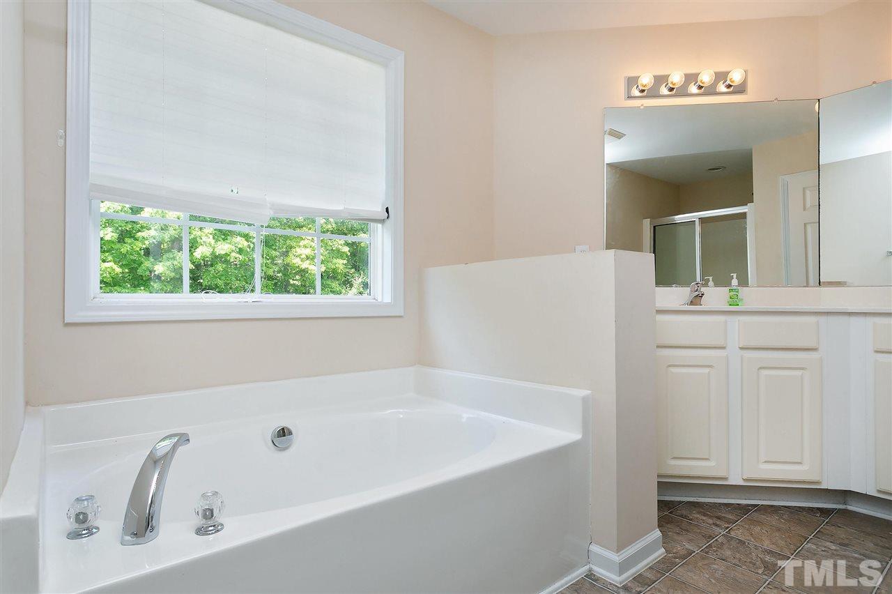 220 Mickleson Ridge Drive Raleigh, NC 27603 - Photo 10 of 20 a white bath tub sitting next to a white sink