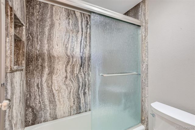 a en suite bathroom with sinks granite countertop and a mirror