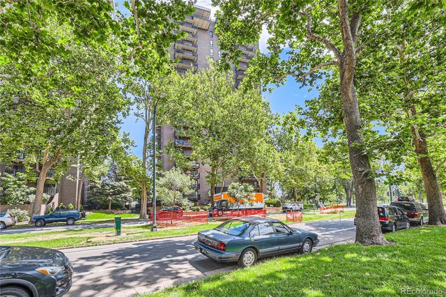 a view of a street with a yard