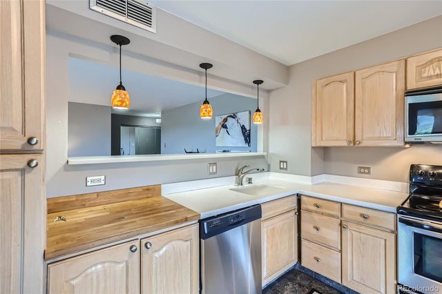 a kitchen with a sink cabinets and appliances
