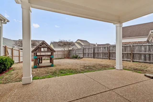 a view of backyard with a garden and deck