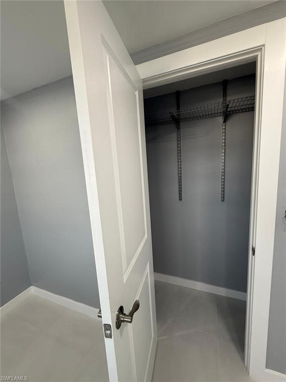 5317 Fleming Street Naples, FL 34113 - Photo 3 of 8 Interior closet featuring wire shelving, white trim, and a paneled door with brushed nickel hardware
