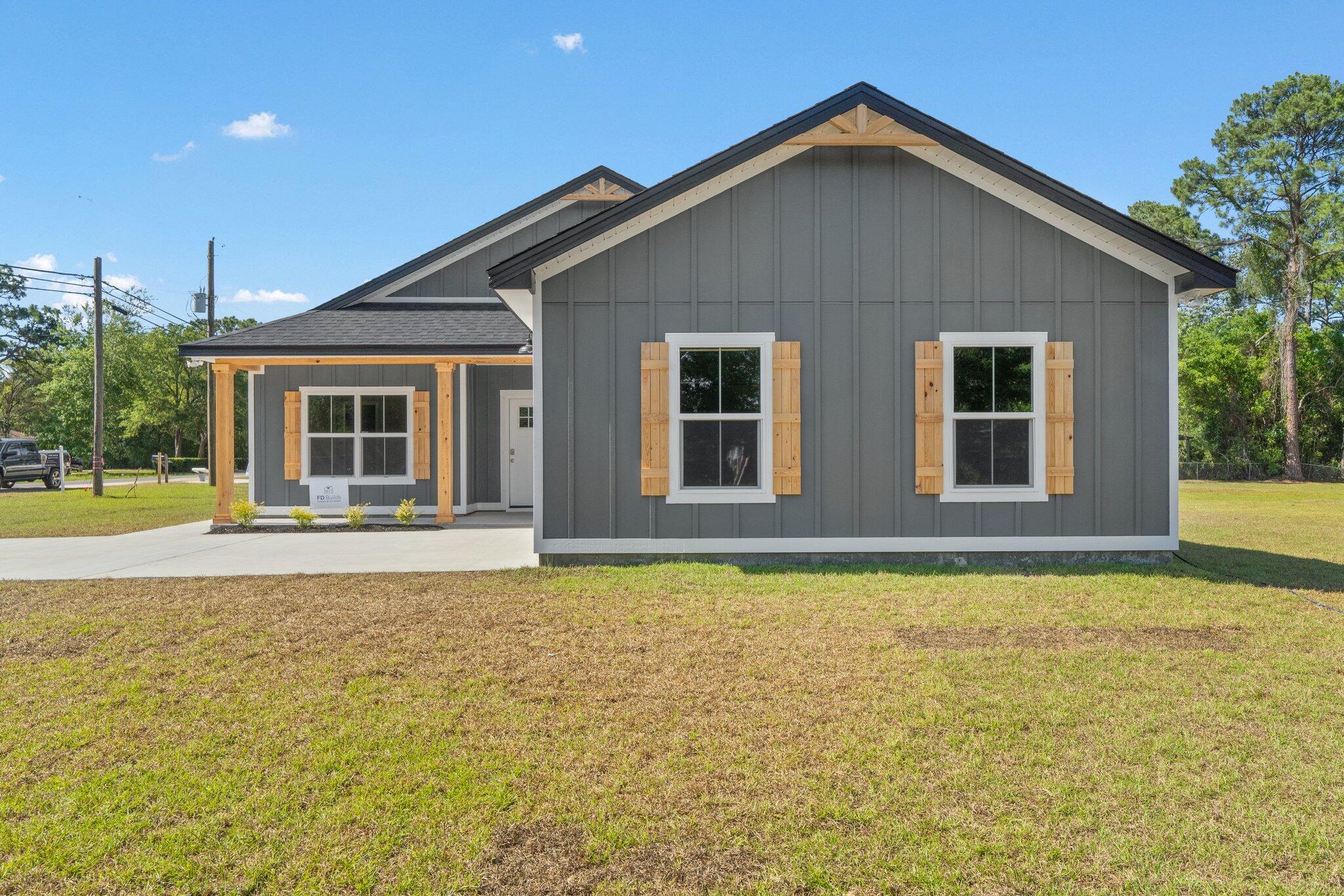 8370 Sevilla Street Navarre, FL 32566 - Photo 1 of 12 a house with swimming pool in front of it