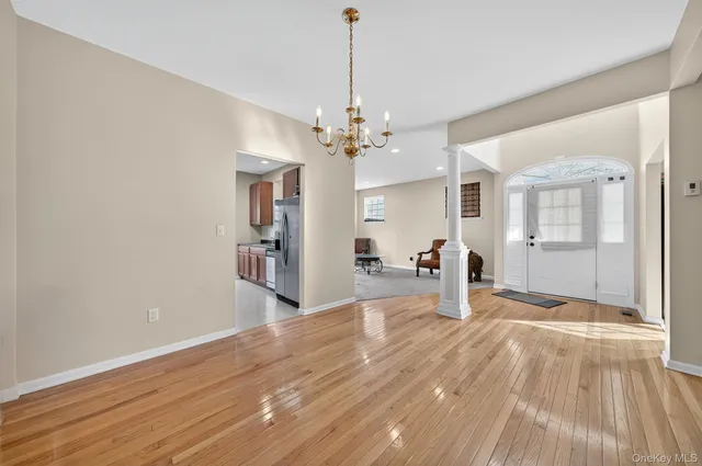 a view of a livingroom with wooden floor and a ceiling fan
