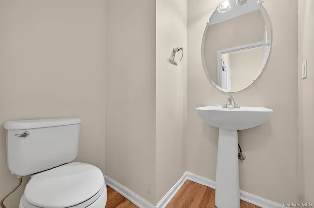 a white toilet sitting next to a bathroom sink