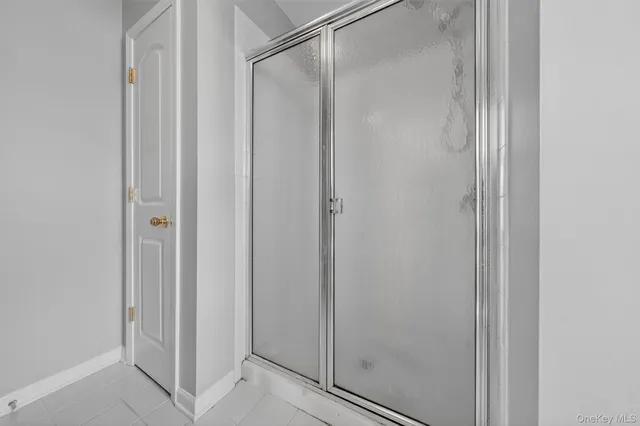a bathroom with a glass shower door