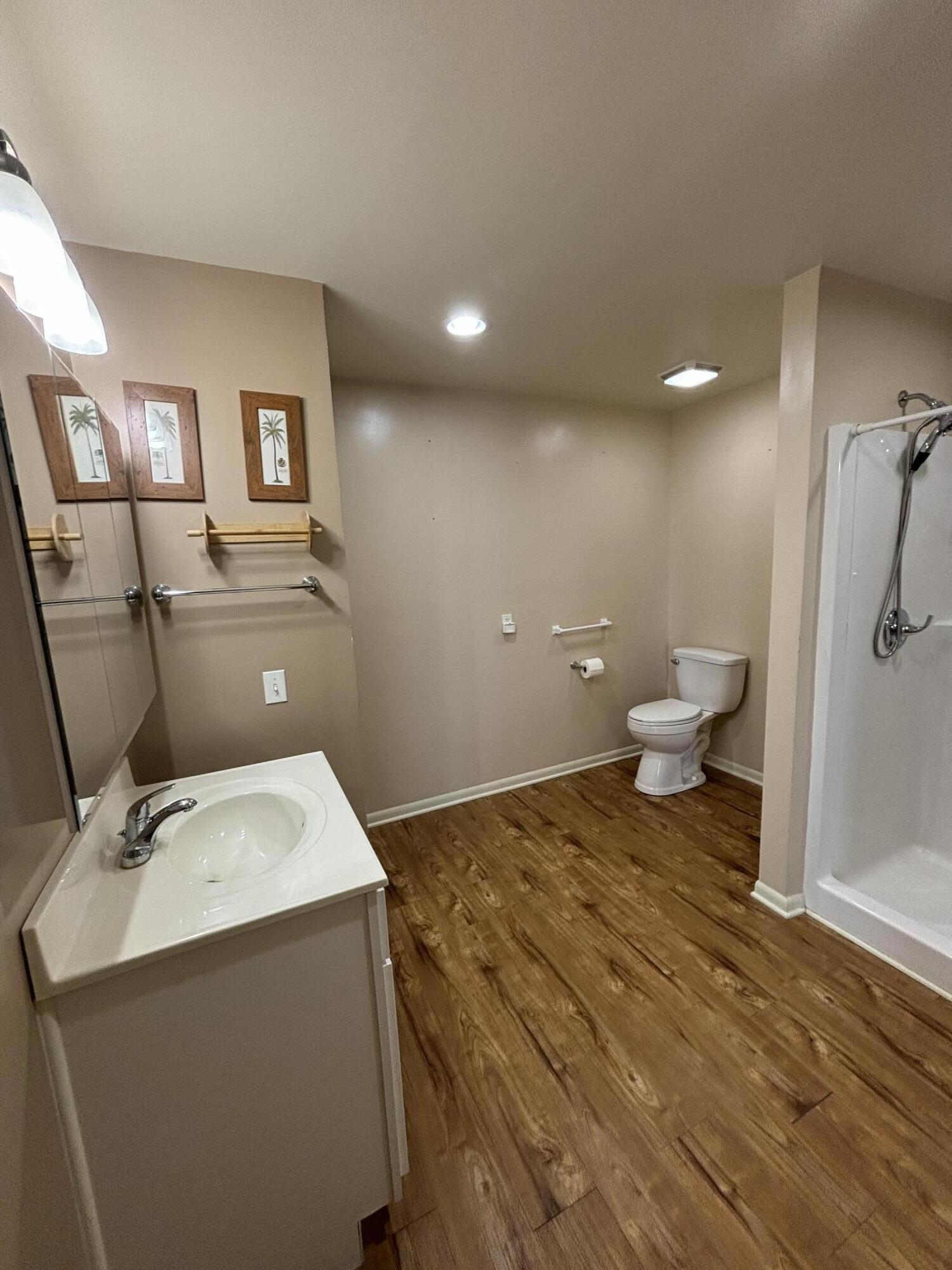 228 West Barker Avenue, Unit 1 Michigan City, IN 46360 - Photo 4 of 7 a bathroom with a sink toilet and shower