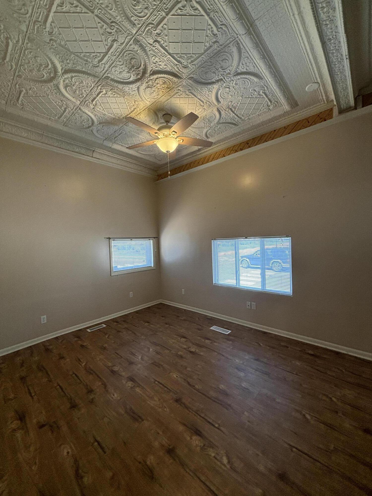 228 West Barker Avenue, Unit 1 Michigan City, IN 46360 - Photo 5 of 7 a view of an empty room with wooden floor