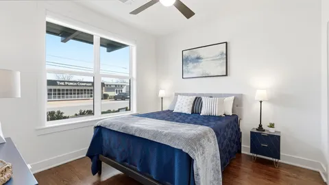 a bedroom with a bed and a window