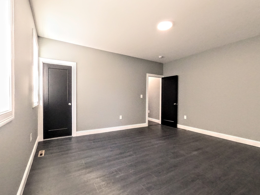 2 Sunnyside Street, Unit 1 Boston, MA 02130 - Photo 13 of 31 a view of an empty room with wooden floor