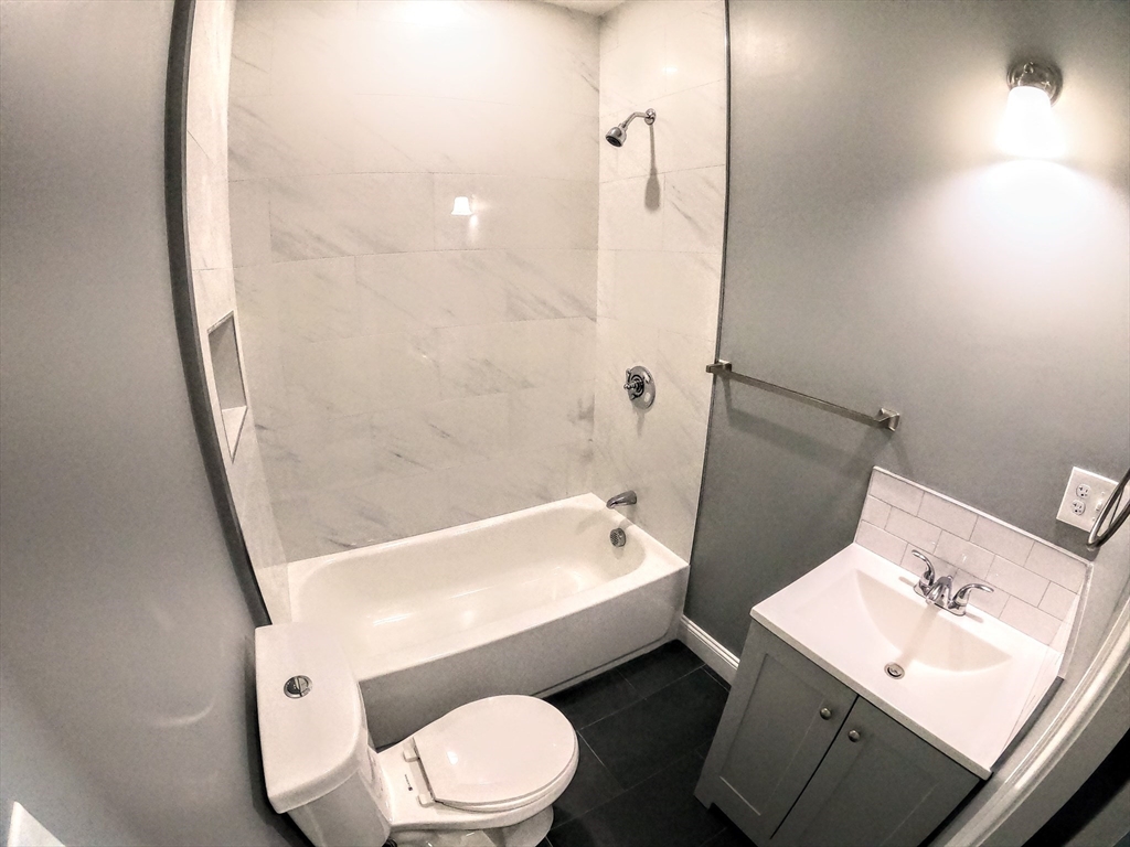 2 Sunnyside Street, Unit 1 Boston, MA 02130 - Photo 28 of 31 a bathroom with a sink a toilet and shower