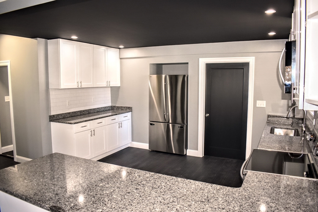 2 Sunnyside Street, Unit 1 Boston, MA 02130 - Photo 10 of 31 a kitchen with a refrigerator and a sink