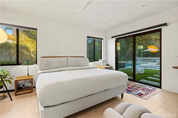 a bedroom with a bed and glass window