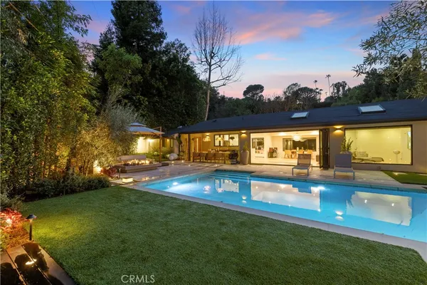 a view of a swimming pool with an outdoor seating and deck