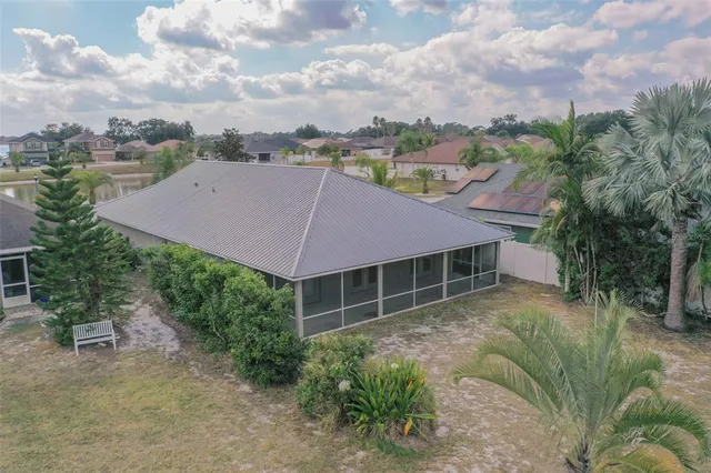 a aerial view of a house with a yard and sitting area