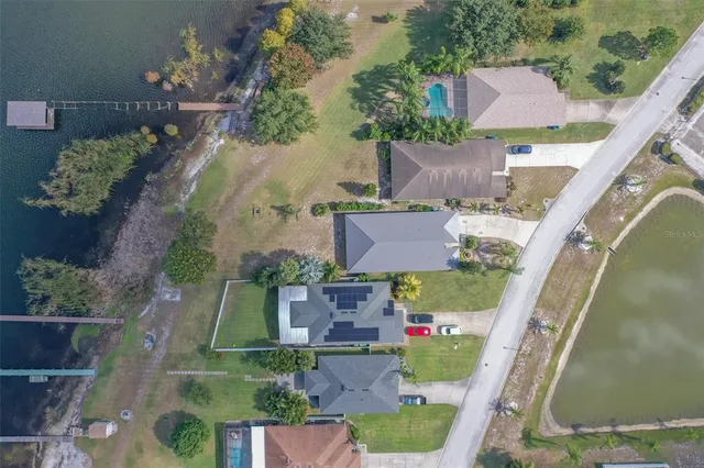 an aerial view of house with a yard