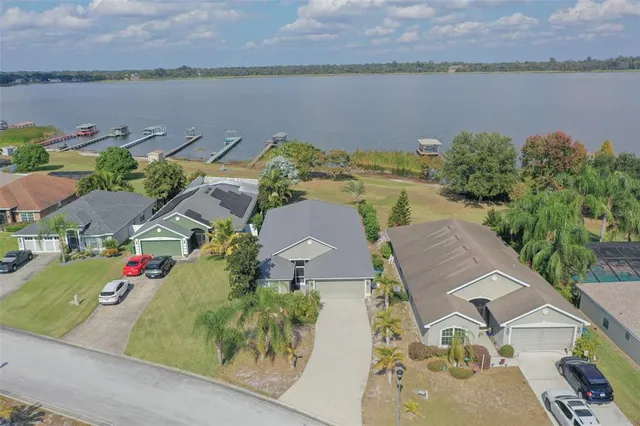 an aerial view of a house with a lake view