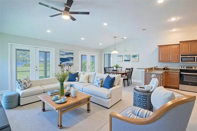 a living room with furniture and kitchen view