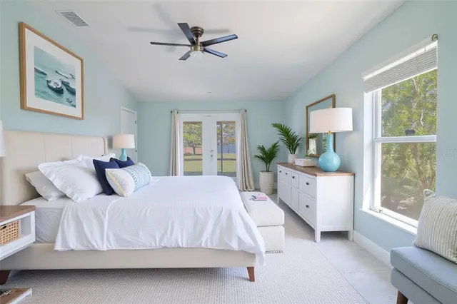 a bedroom with a large bed and a window