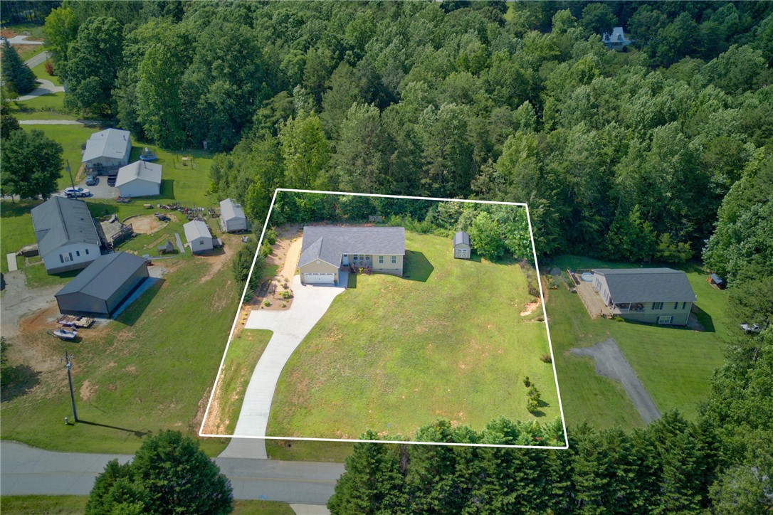405 Pawnee Drive Walhalla, SC 29691 - Photo 30 of 36 An aerial perspective reveals a serene residence nestled amidst abundant mature trees, offering ample green space and seclusion.