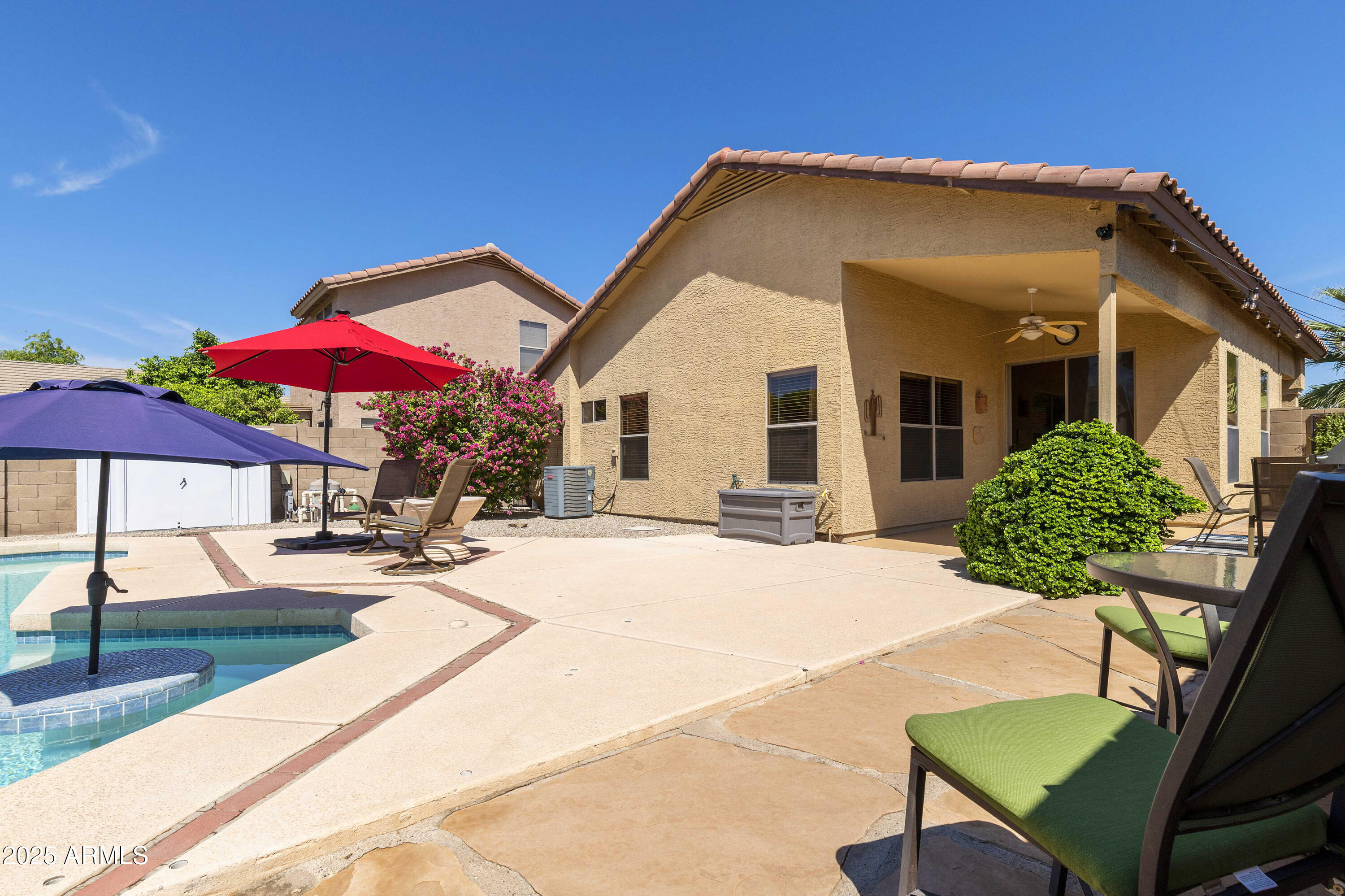 519 East Devon Drive Gilbert, AZ 85296 - Photo 11 of 47 a patio with a table and chairs under an umbrella