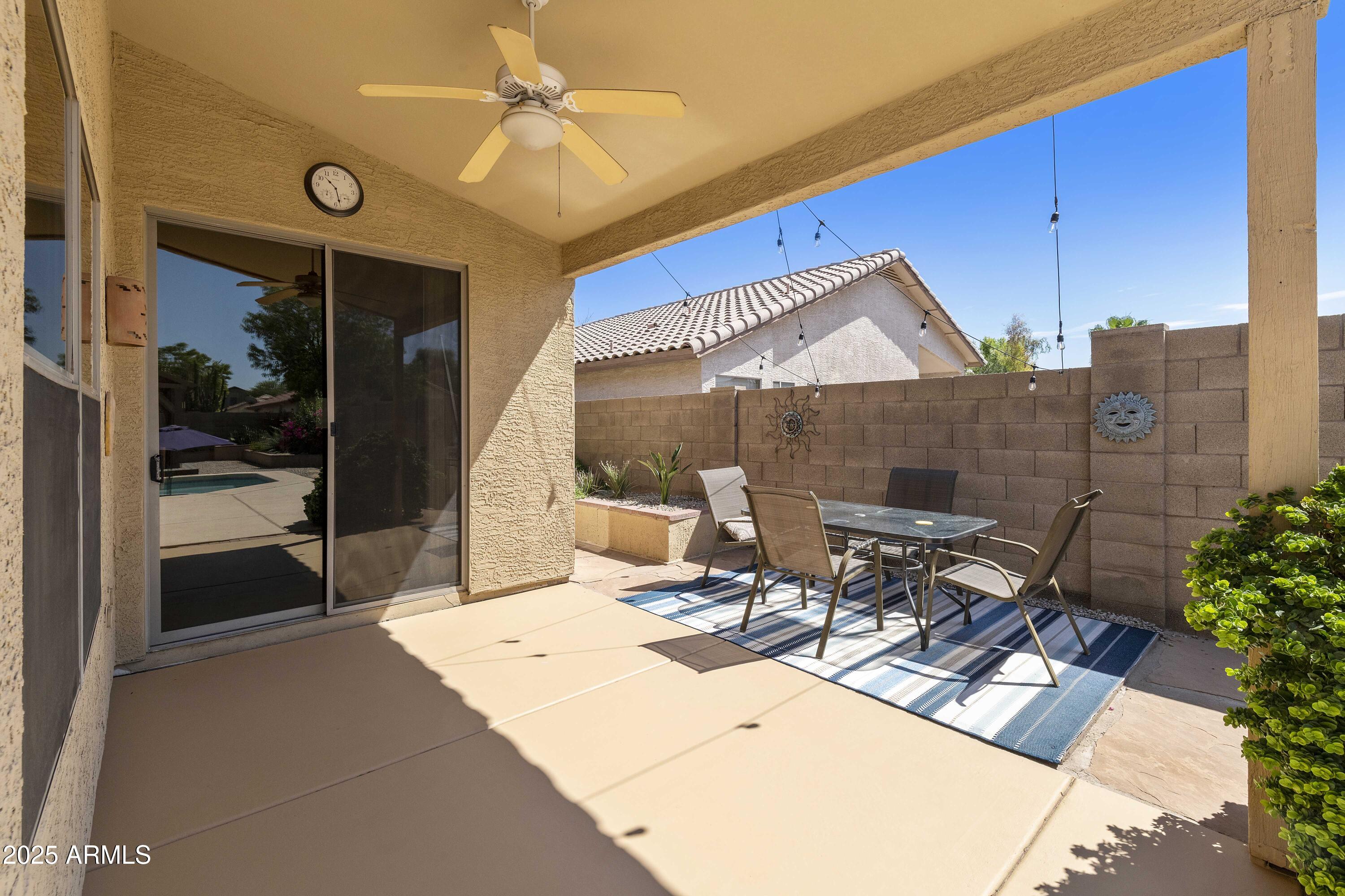 519 East Devon Drive Gilbert, AZ 85296 - Photo 12 of 47 a building outdoor space with patio furniture and potted plants