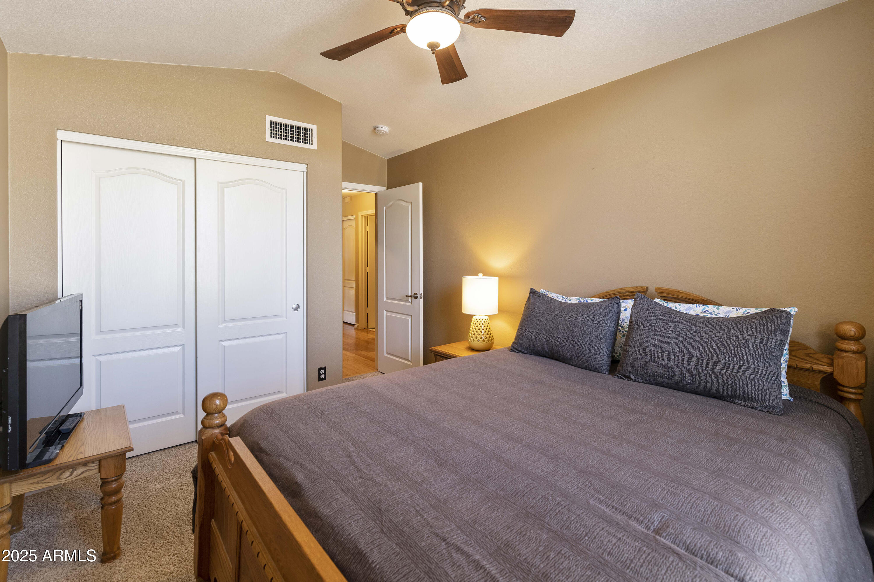 519 East Devon Drive Gilbert, AZ 85296 - Photo 18 of 47 a bedroom with a bed and a chandelier