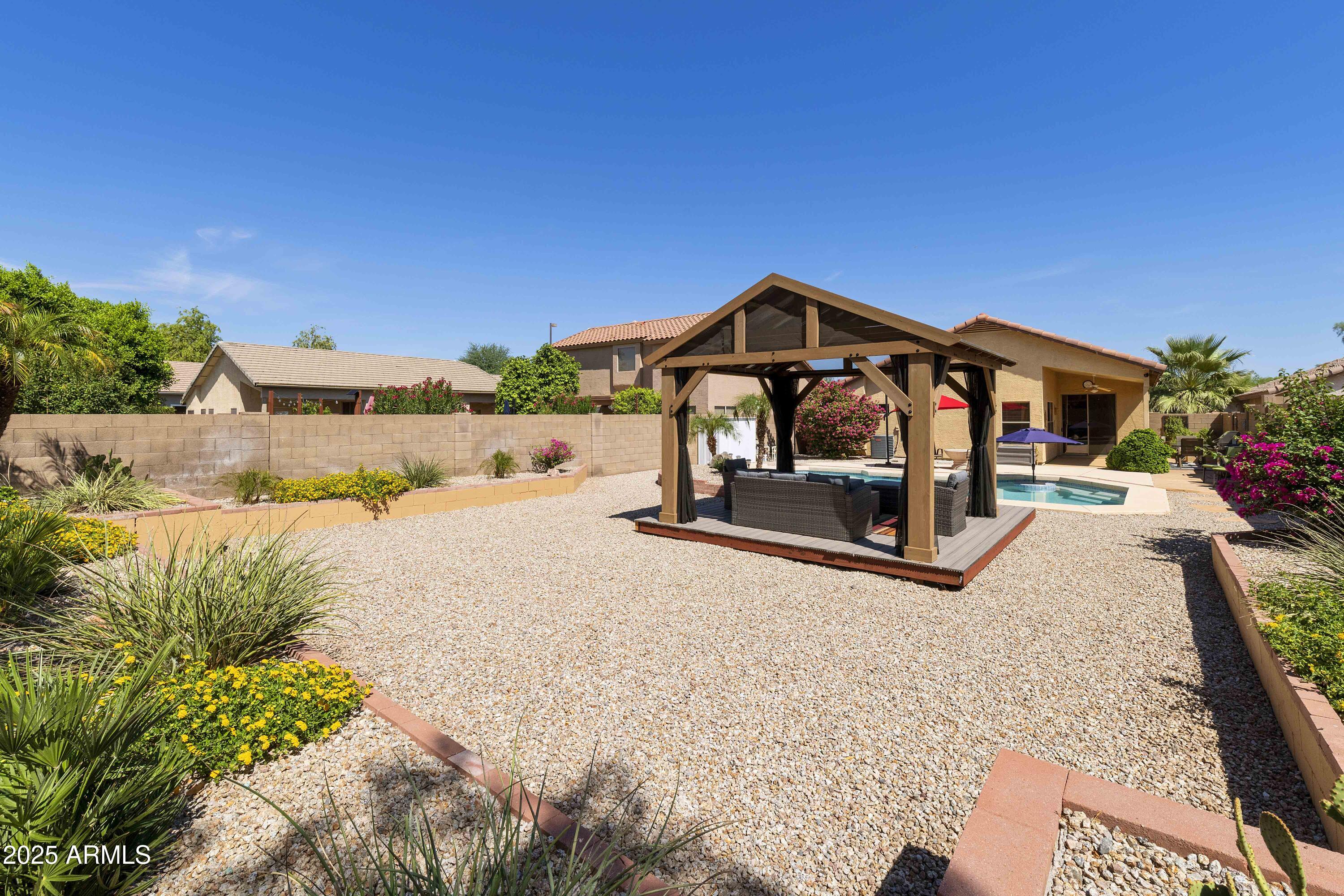 519 East Devon Drive Gilbert, AZ 85296 - Photo 22 of 47 a front view of a house with a yard