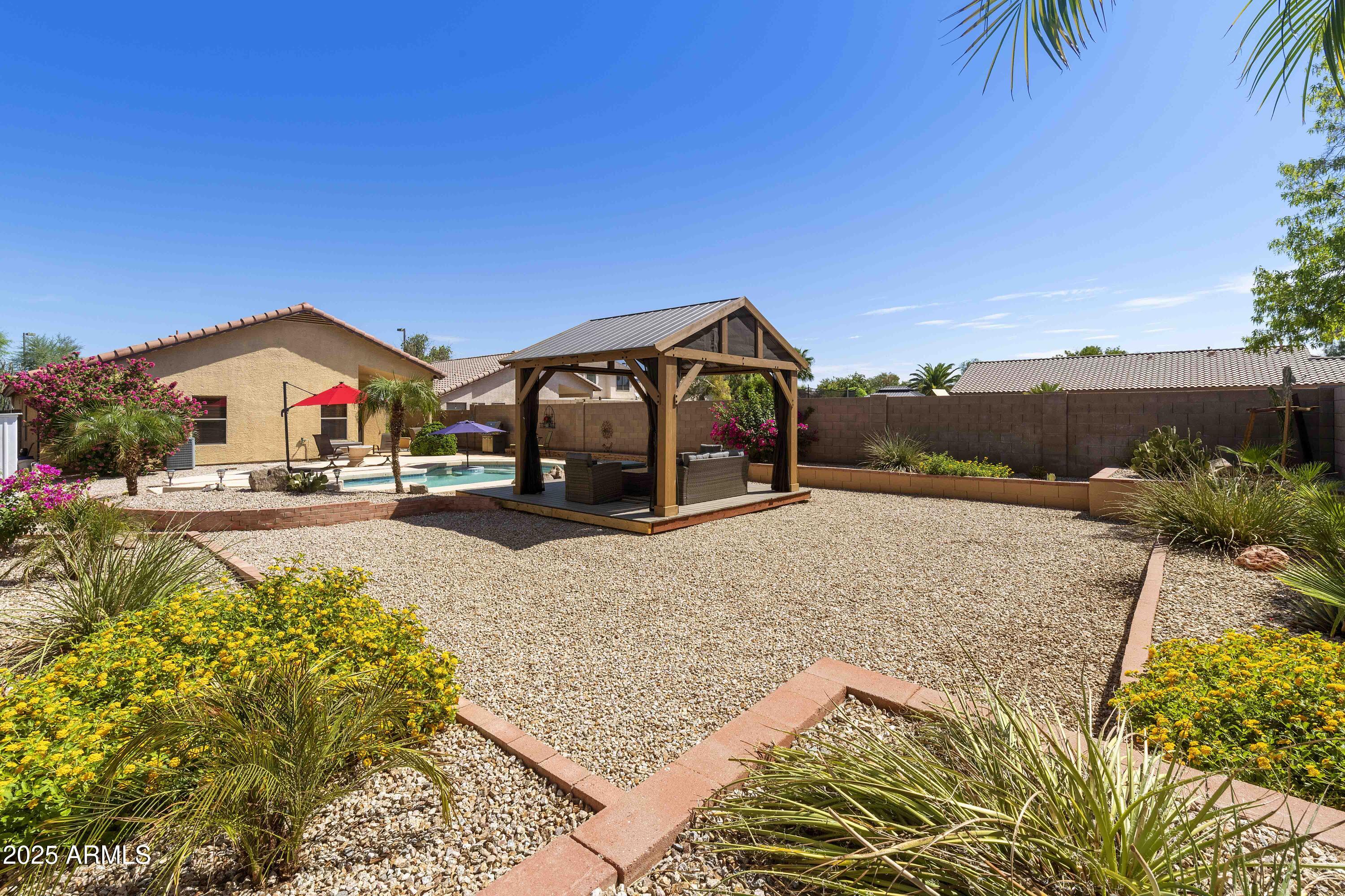 519 East Devon Drive Gilbert, AZ 85296 - Photo 23 of 47 a view of an house with swimming pool and mountains