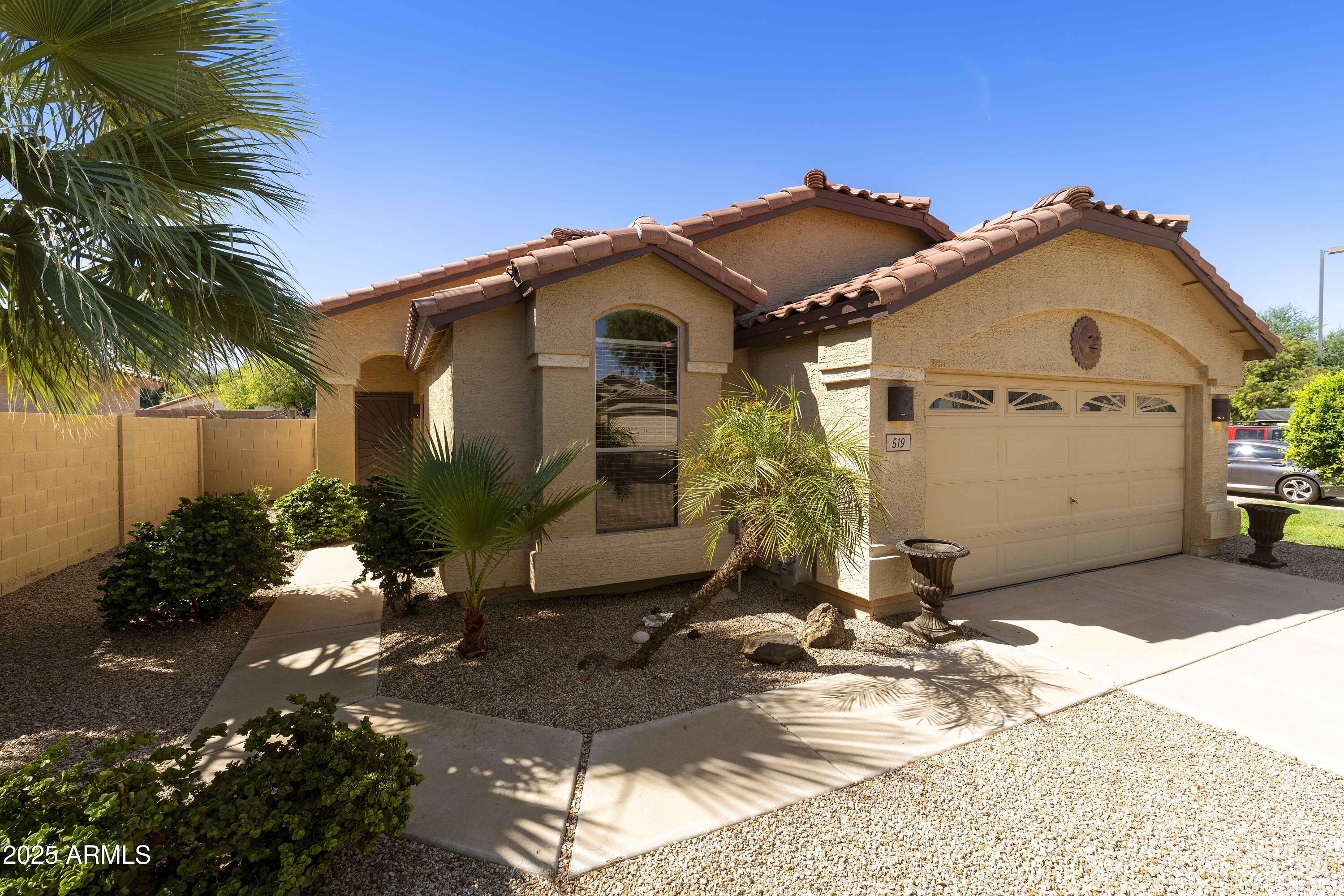 519 East Devon Drive Gilbert, AZ 85296 - Photo 26 of 47 a front view of a house with a yard