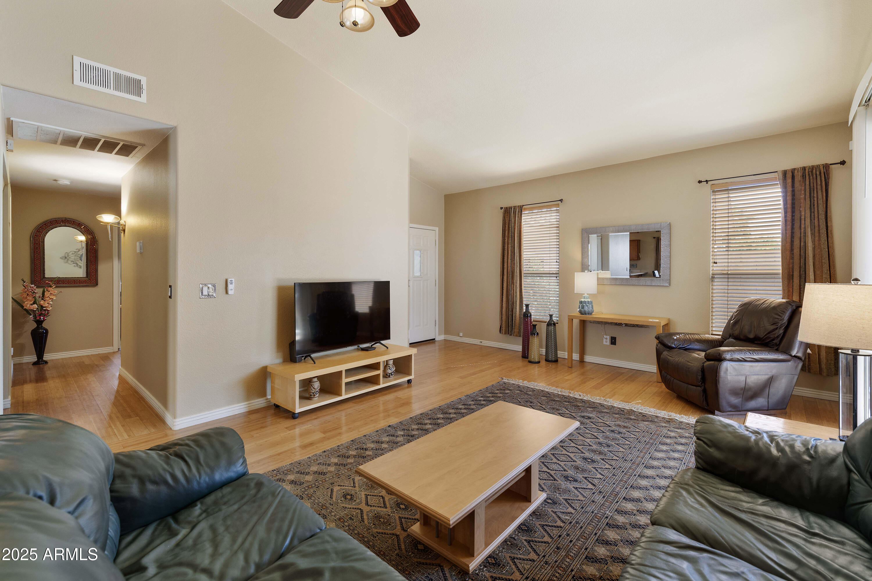 519 East Devon Drive Gilbert, AZ 85296 - Photo 33 of 47 a living room with furniture and a flat screen tv