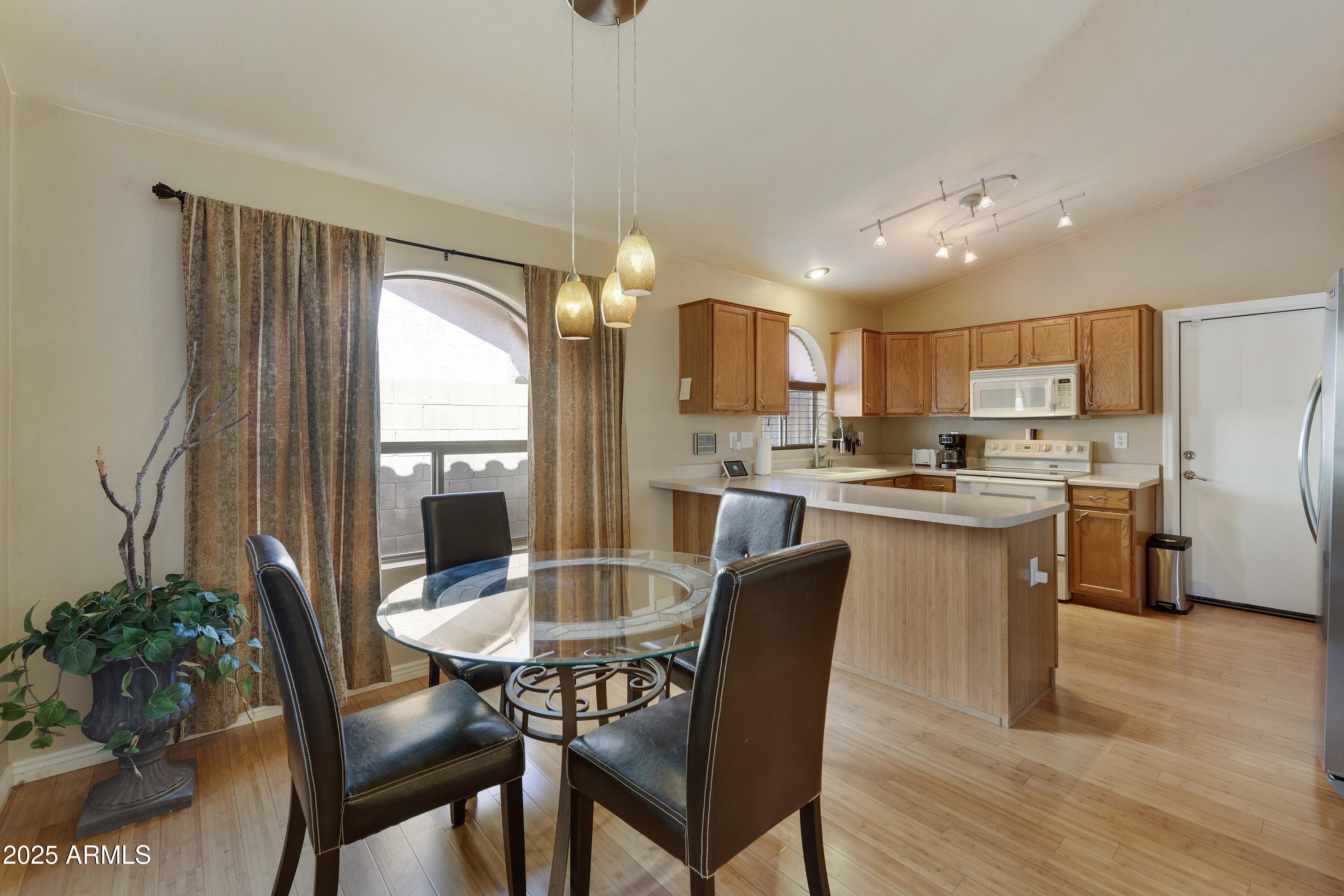 519 East Devon Drive Gilbert, AZ 85296 - Photo 36 of 47 a kitchen with a table and chairs in it