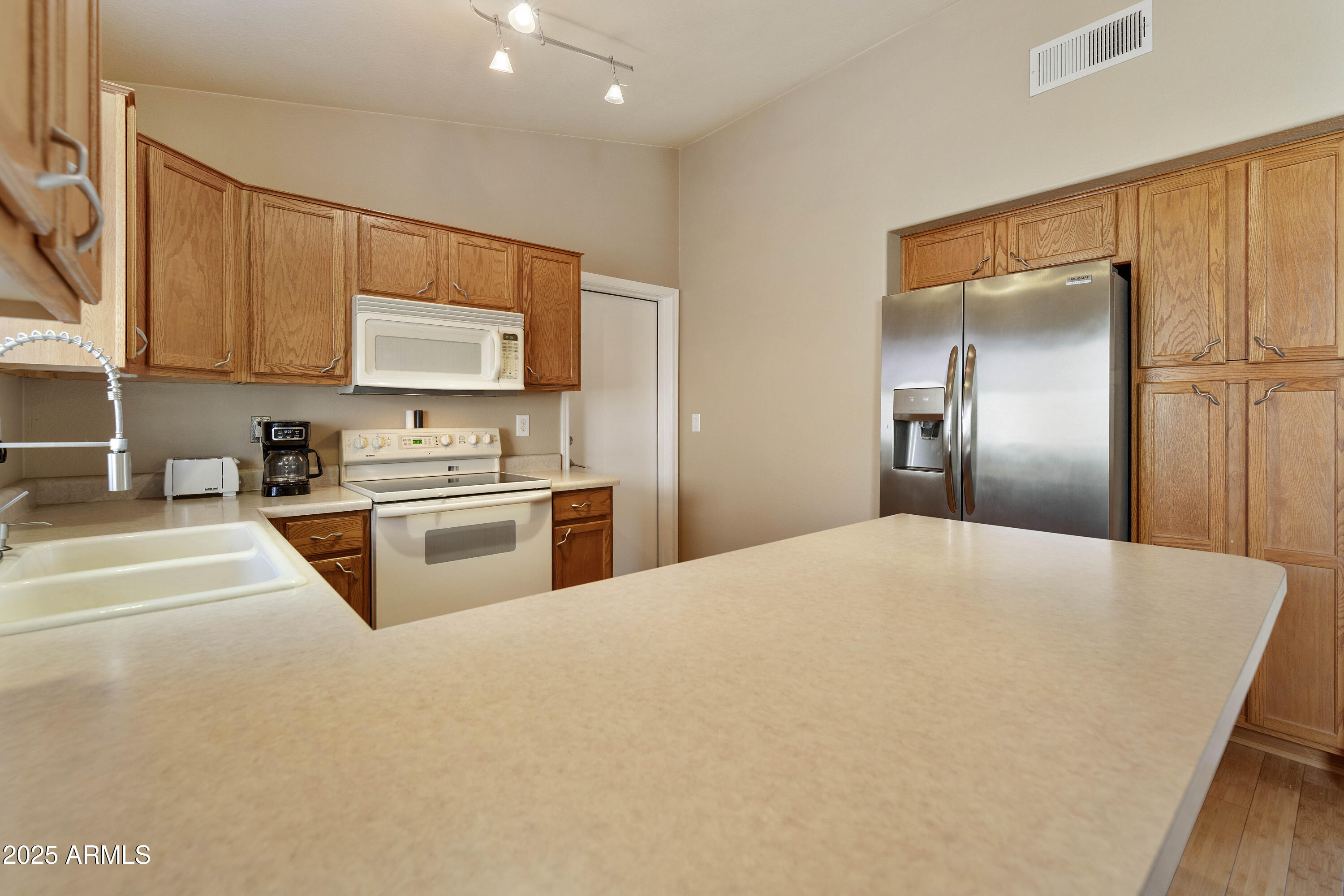 519 East Devon Drive Gilbert, AZ 85296 - Photo 39 of 47 a kitchen with stainless steel appliances a refrigerator sink and cabinets