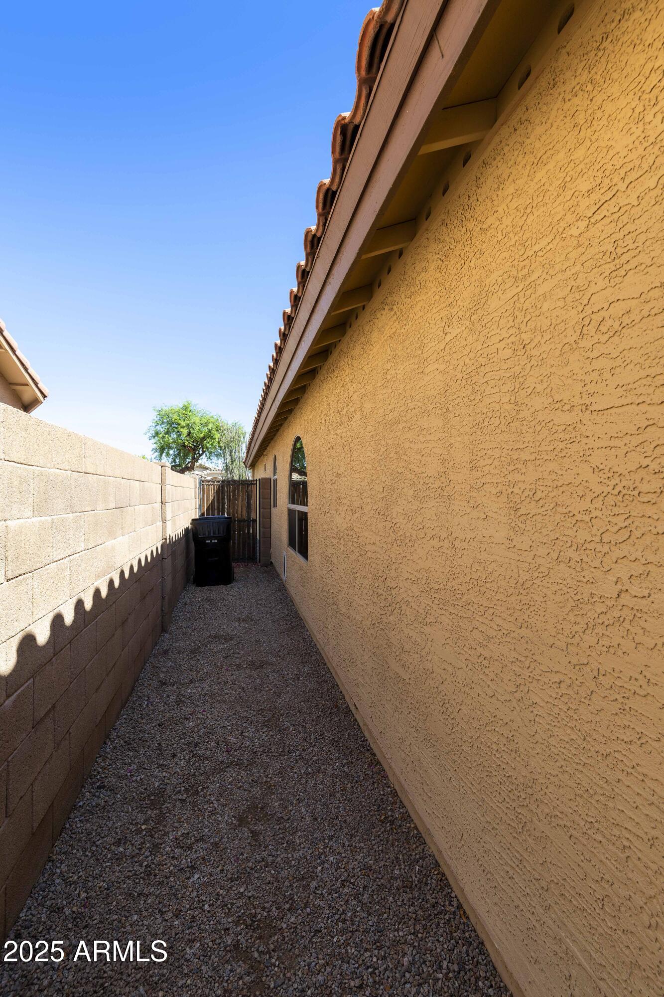 519 East Devon Drive Gilbert, AZ 85296 - Photo 7 of 47 a view of a pathway both side of building