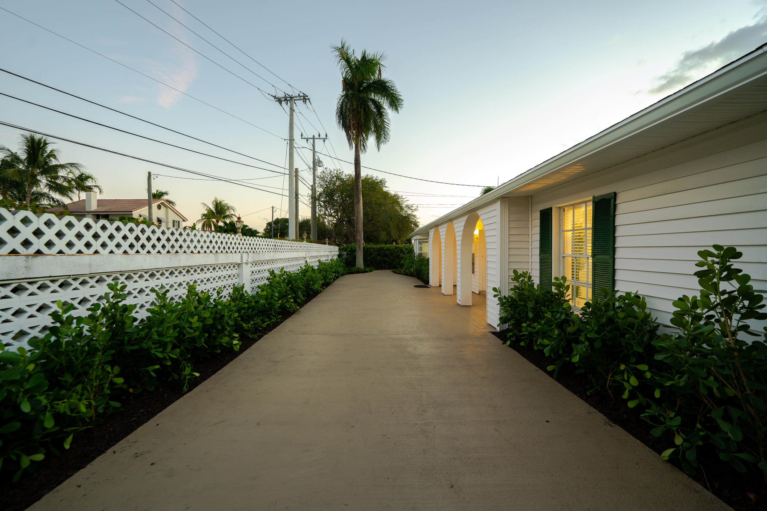 3199 Northeast 6th Drive Boca Raton, FL 33431 - Photo 8 of 49 a view of a house with a small yard and flower plants