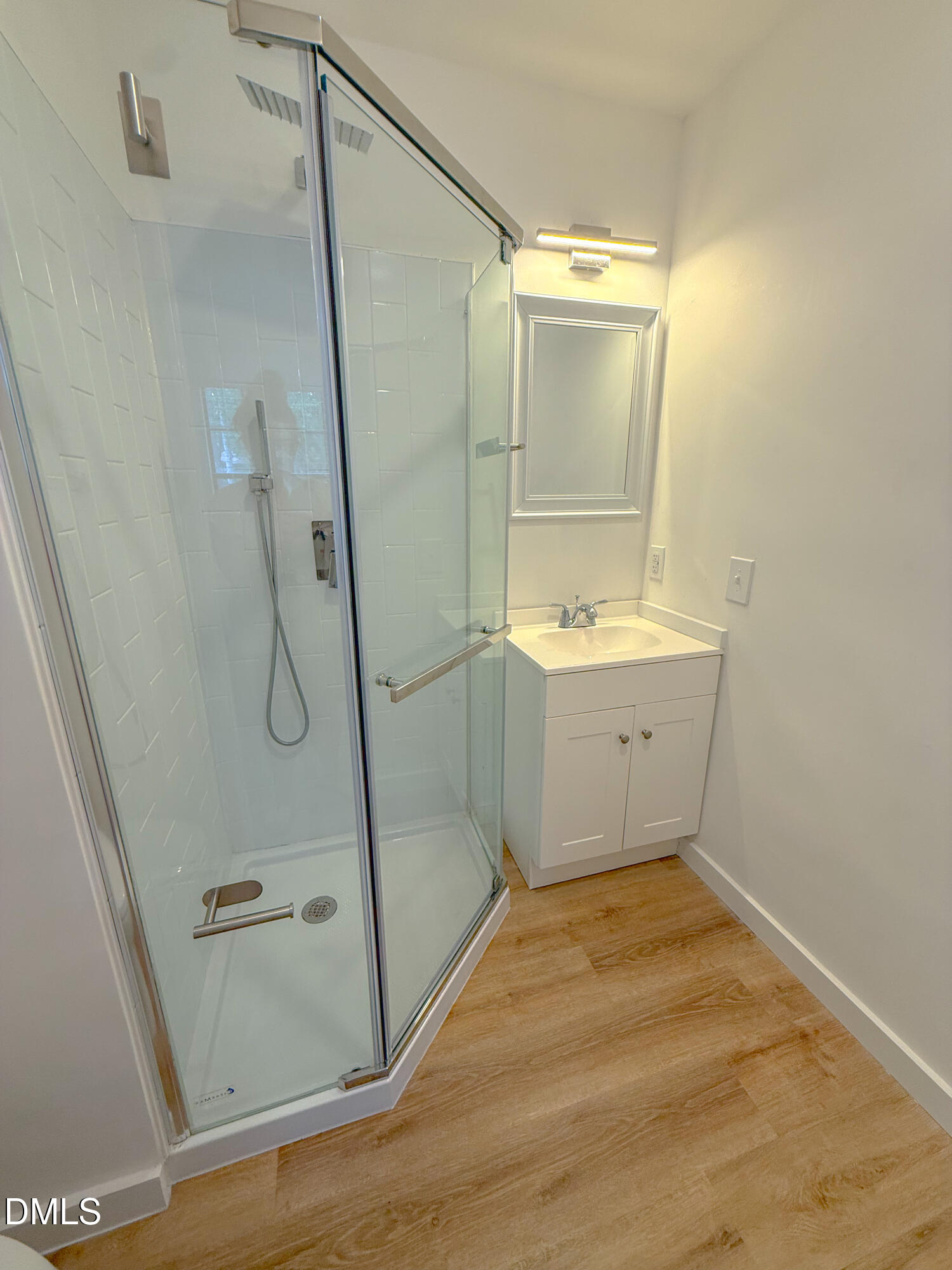 4247 The Oaks Drive Raleigh, NC 27606 - Photo 17 of 21 a bathroom with a sink and shower