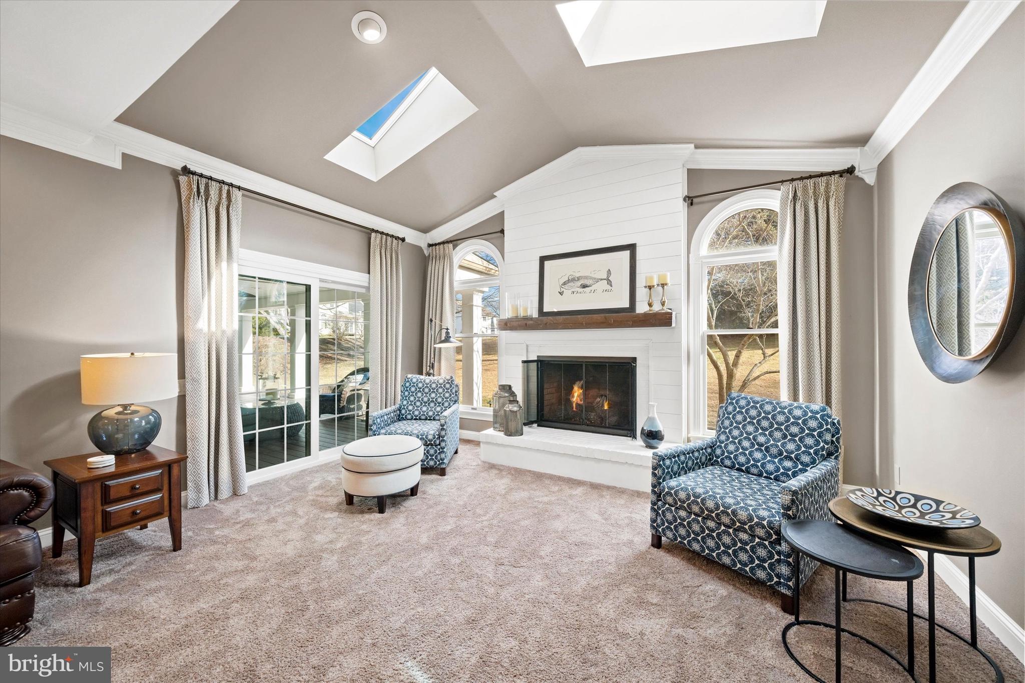 716 Regency Hill Road Hockessin, DE 19707 - Photo 14 of 73 a living room with furniture a fireplace and a floor to ceiling window