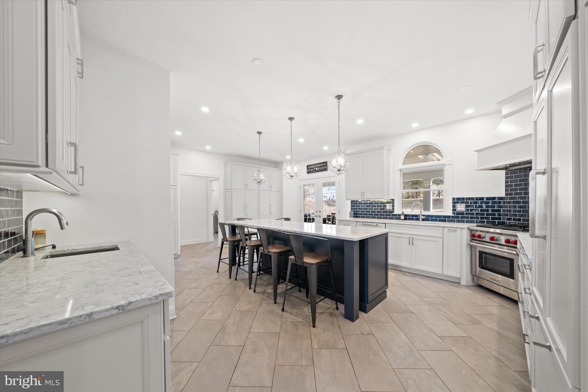 716 Regency Hill Road Hockessin, DE 19707 - Photo 18 of 73 a large kitchen with kitchen island a sink a stove a dining table and chairs