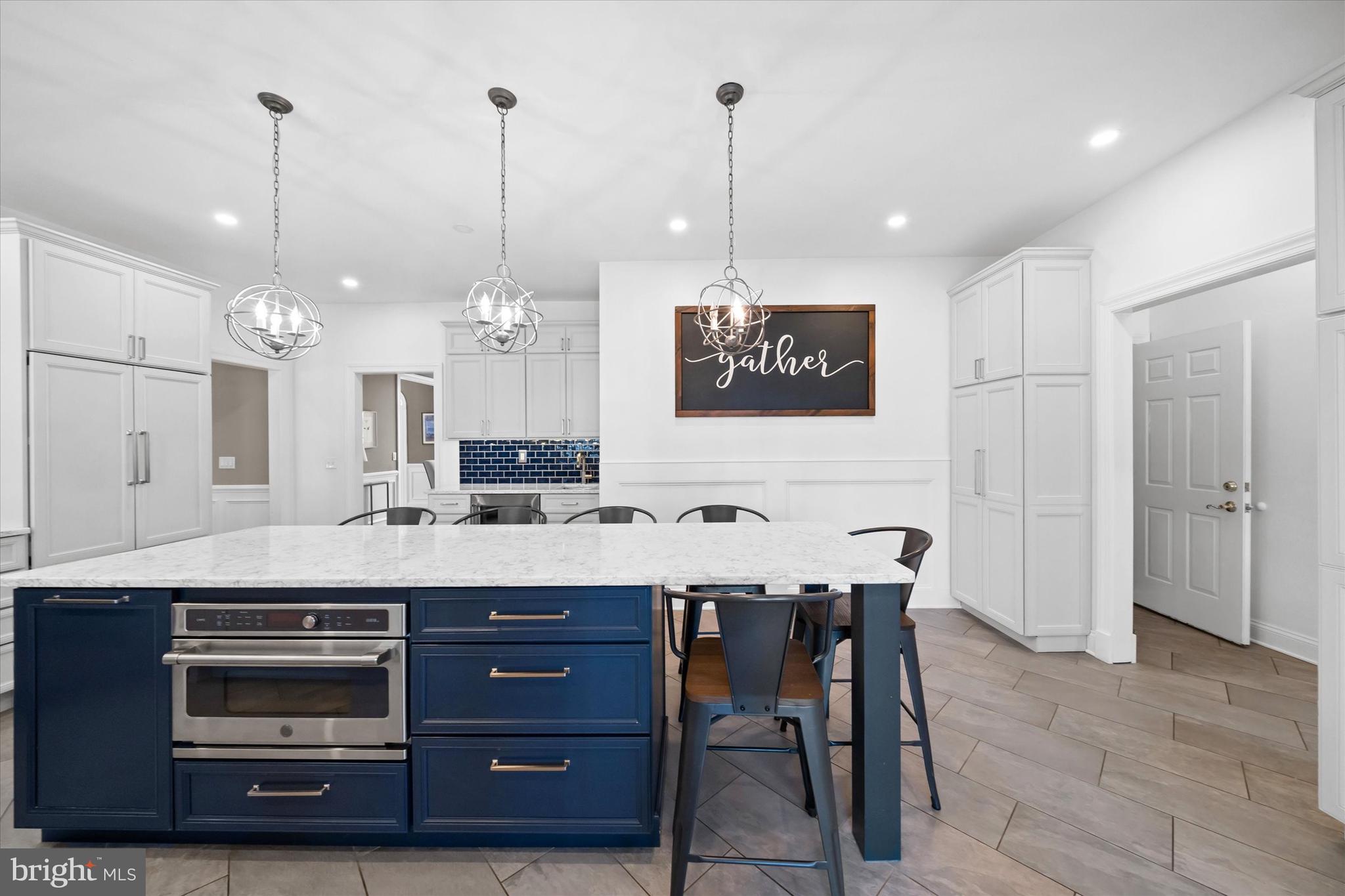 716 Regency Hill Road Hockessin, DE 19707 - Photo 25 of 73 a view of a kitchen with a center island and cabinets