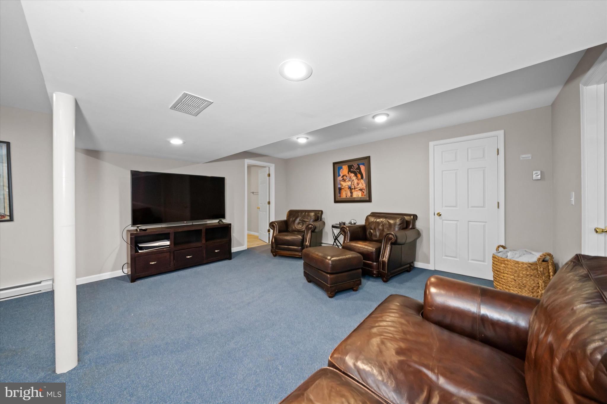 716 Regency Hill Road Hockessin, DE 19707 - Photo 54 of 73 a living room with furniture and a flat screen tv