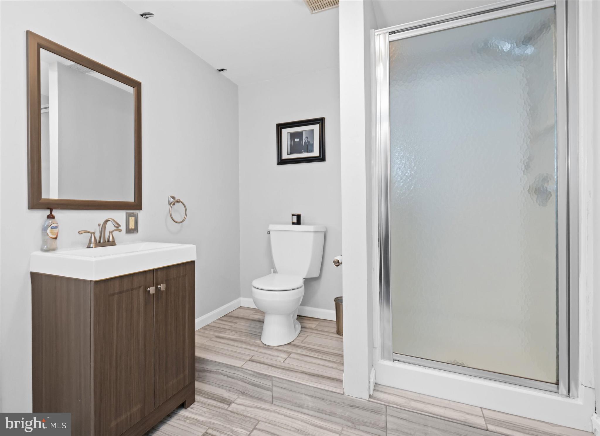 716 Regency Hill Road Hockessin, DE 19707 - Photo 57 of 73 a bathroom with a toilet sink and mirror
