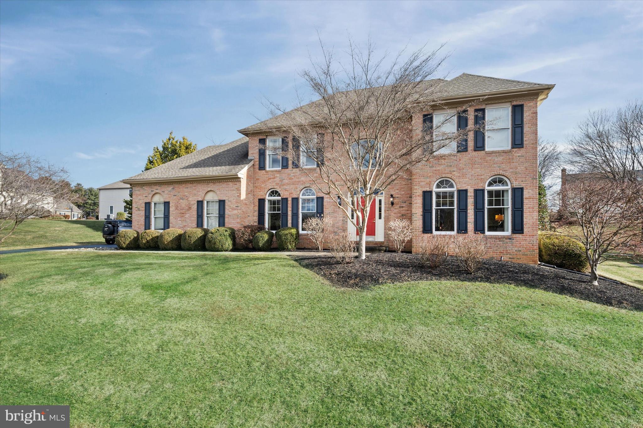 716 Regency Hill Road Hockessin, DE 19707 - Photo 64 of 73 a front view of a house with a garden and yard