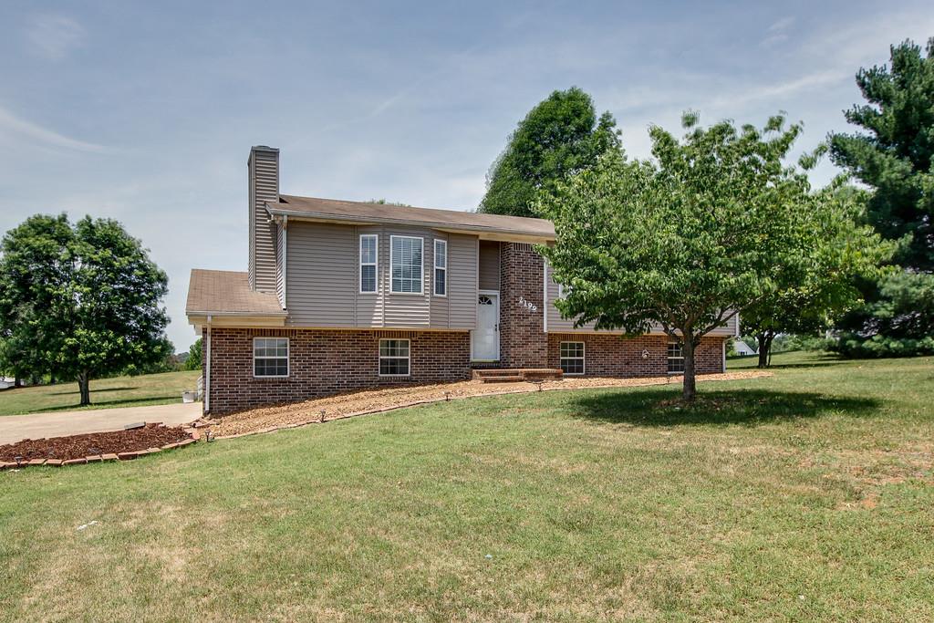 2199 Clara Mathis Road Spring Hill, TN 37174 - Photo 24 of 24 a view of a house with a yard and a large tree