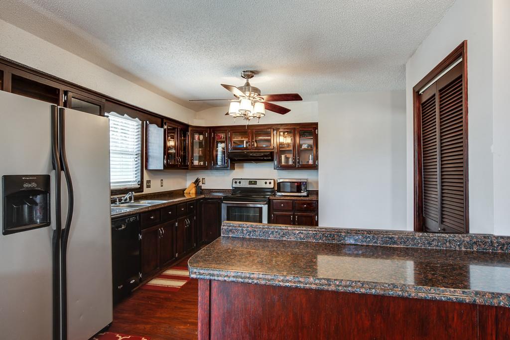 2199 Clara Mathis Road Spring Hill, TN 37174 - Photo 4 of 24 a kitchen with stainless steel appliances granite countertop a sink a stove and a refrigerator