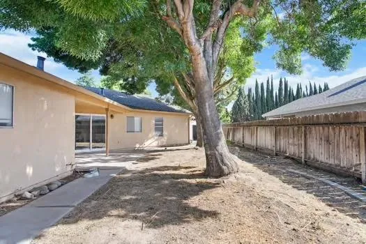 a view of a house with a tree in the background